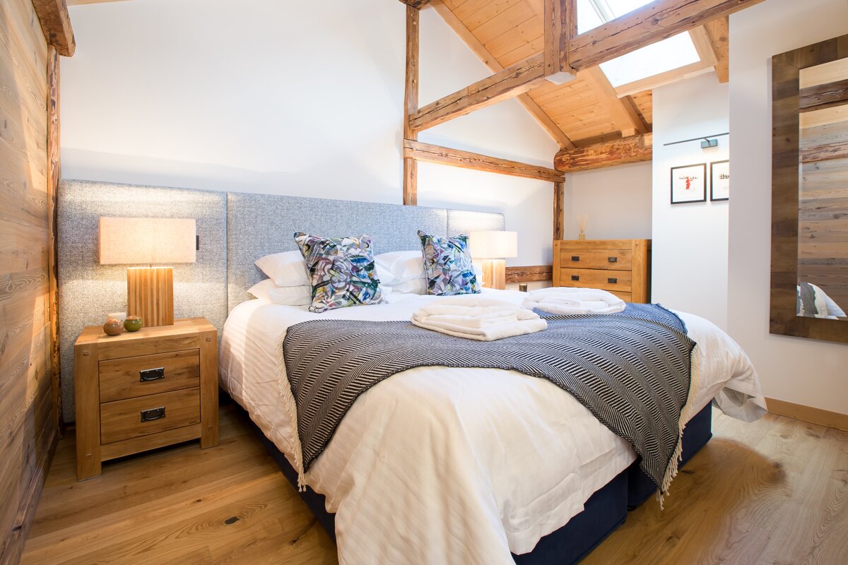 A bedroom with a king size bed and two nightstands