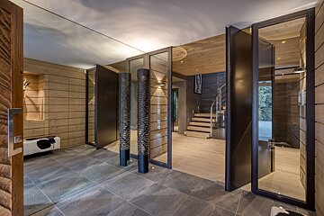 A hallway with a staircase in the background