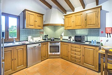 A kitchen with stainless steel appliances and wooden cabinets