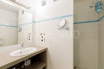 A bathroom with a sink and a mirror that says home sud