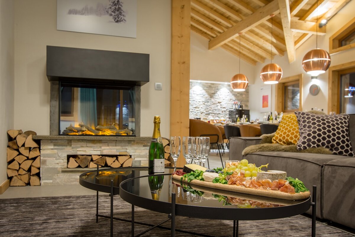 A bottle of champagne sits on a table in a living room