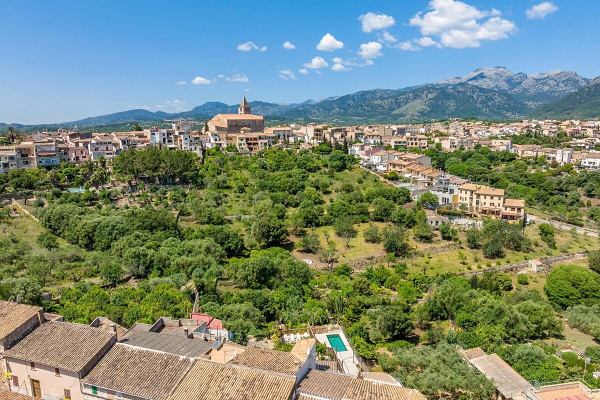 An aerial view of a small town with mountains in the background