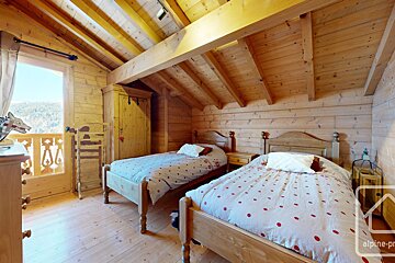 A bedroom with two beds and a sign that says alpine-pro