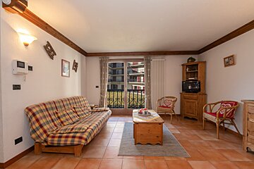 A living room with a couch and two chairs
