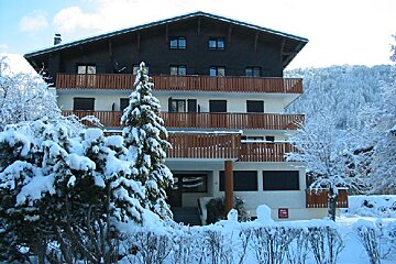 A snowy house with a sign that says ' alquiler ' on it