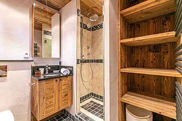 A map of france hangs above a bed in a bedroom