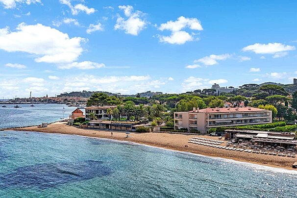 A beach with a large building in the background