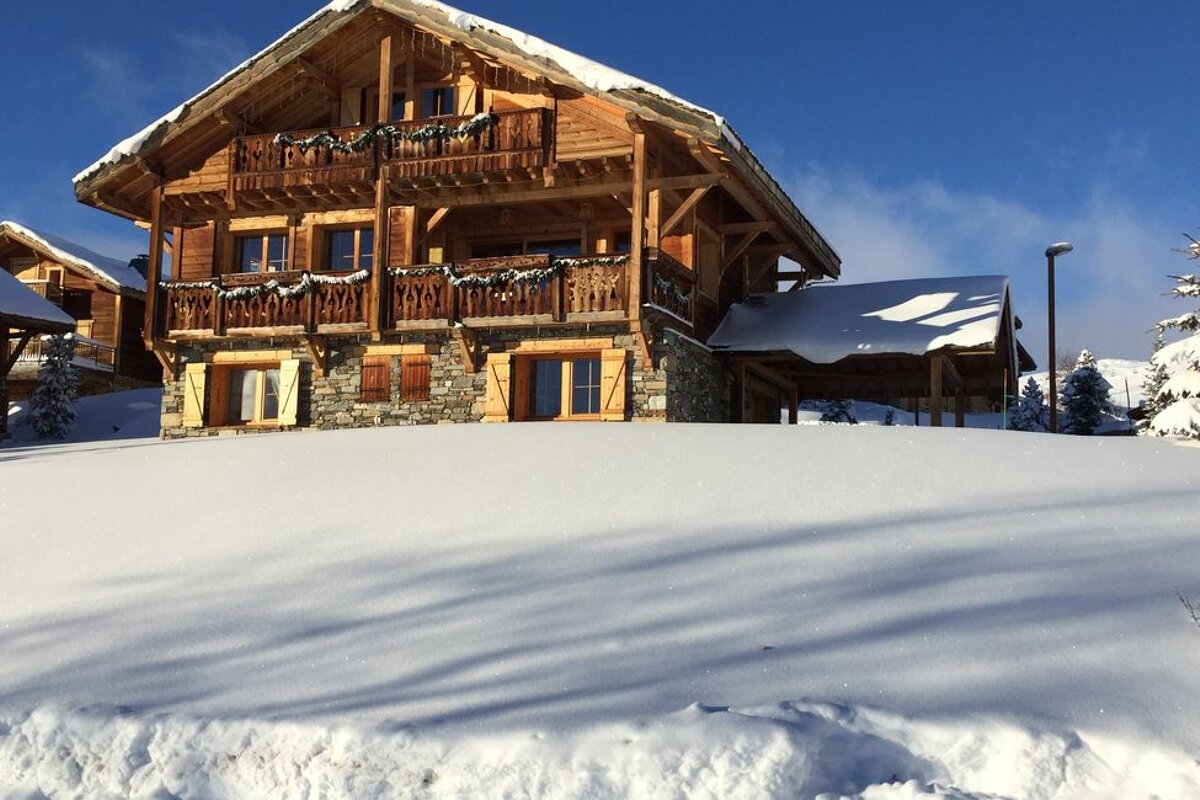 A snowy house with a blue sky in the background