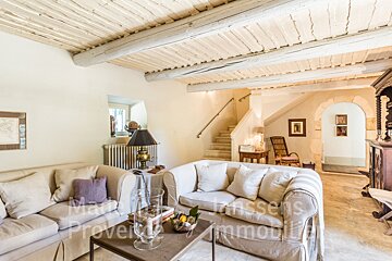 A living room with a couch and a table that says provence immobilier