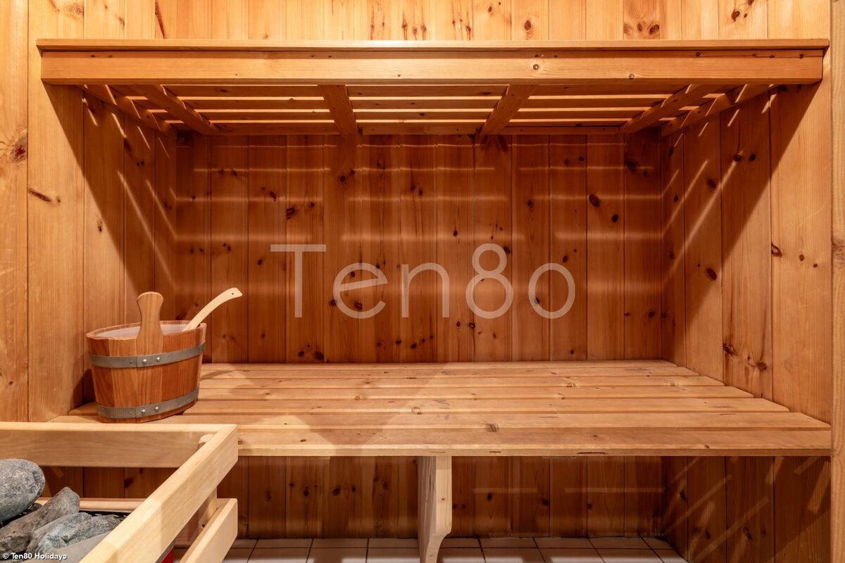 A wooden sauna with the number ten80 on the wall