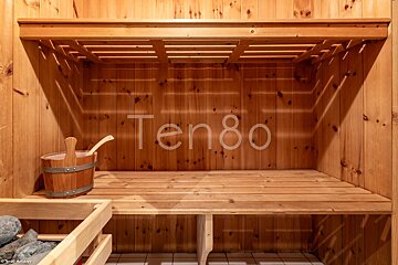 A wooden sauna with the number ten80 on the wall