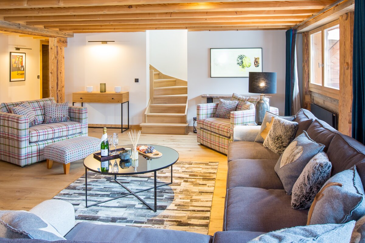 A living room with a couch and two chairs