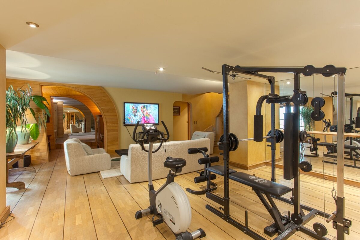 A home gym with a couch and a tv
