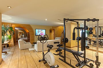 A home gym with a couch and a tv