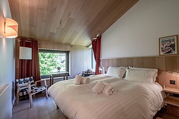 A bedroom with a picture of chamonix on the wall above the bed