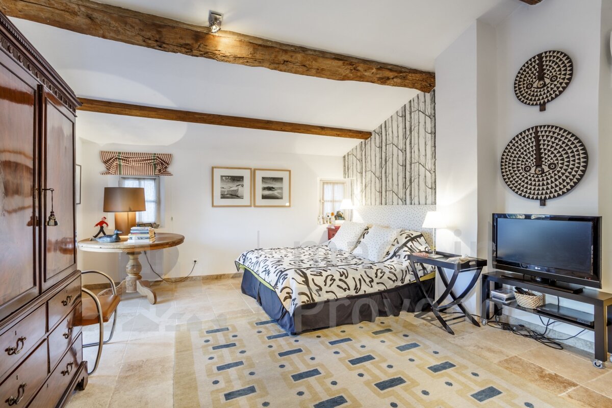 A bedroom with a large bed and a flat screen tv