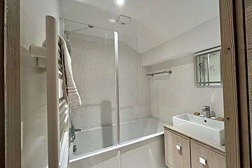 A bathroom with a bathtub and a sink