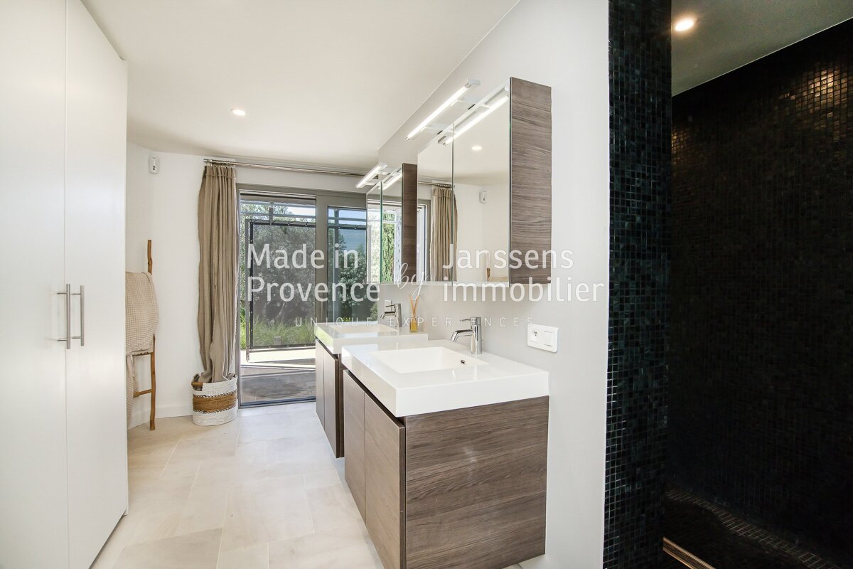A bathroom with two sinks and a sign that says made in provence
