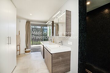 A bathroom with two sinks and a sign that says made in provence