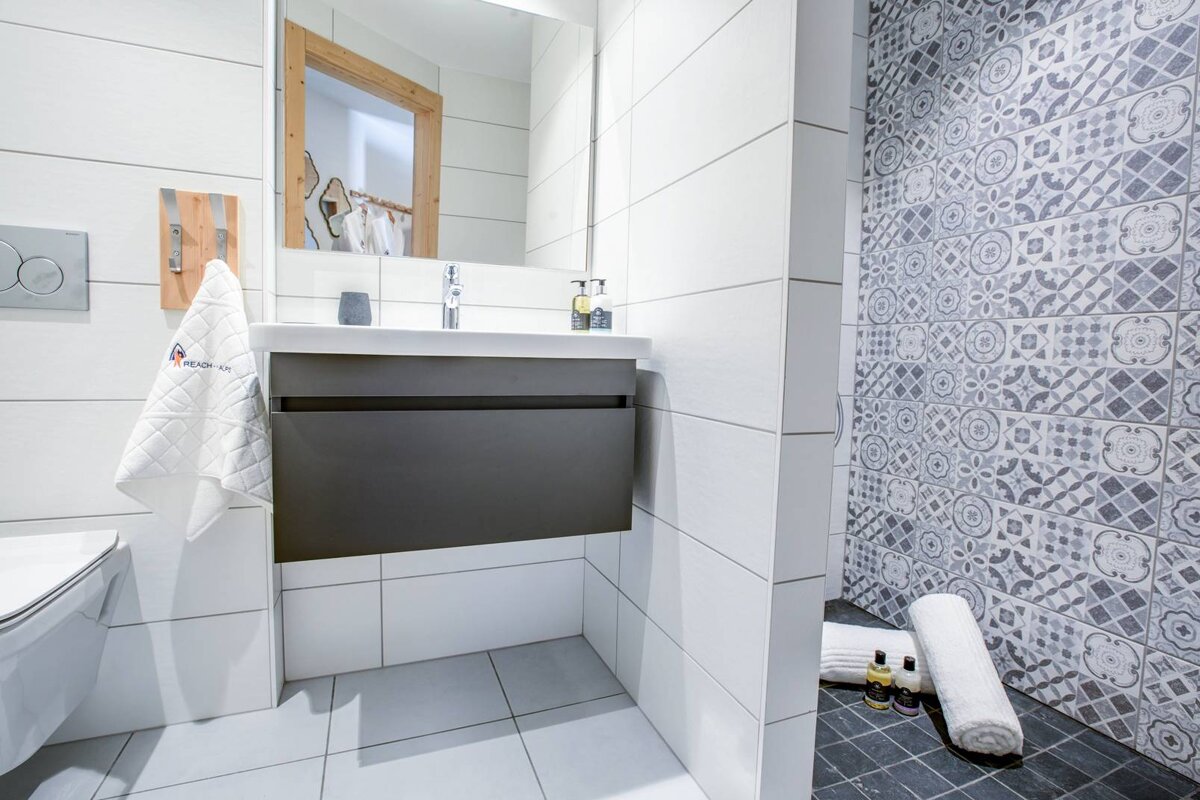 A bathroom with a sink and a towel that says abercrombie