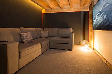 A living room with a couch and a flat screen tv