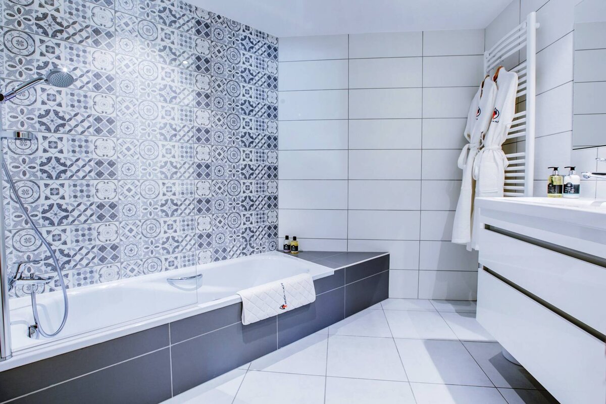 A bathroom with a bathtub a sink and a shower