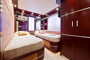 A small bedroom with two beds and a tv