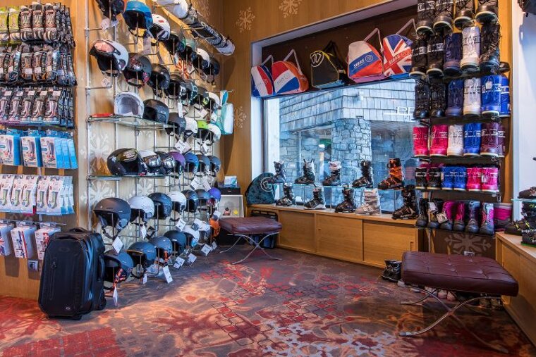 A store filled with lots of ski gear including boots and helmets