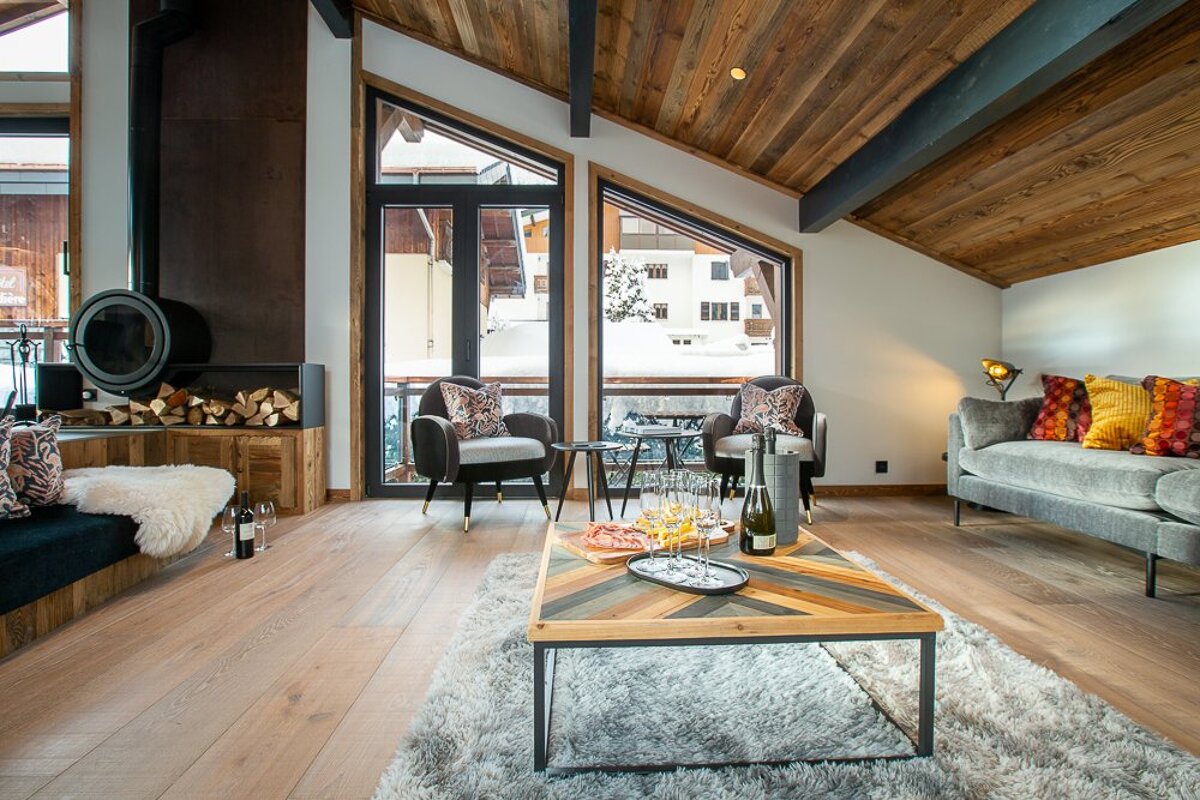 A living room with a couch chairs and a coffee table