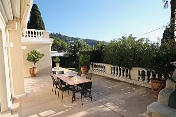 A patio with a table and chairs on it