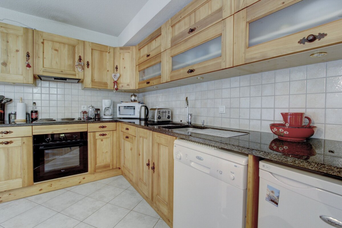 A kitchen with wooden cabinets and a lg dishwasher