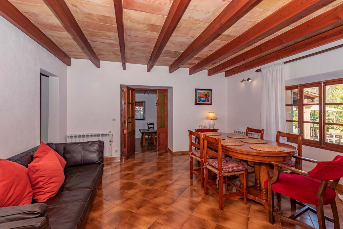 A living room with a couch and a table and chairs