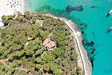 An aerial view of a house on a small island