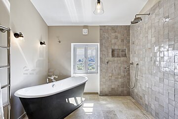 A bathroom with a bathtub and a shower