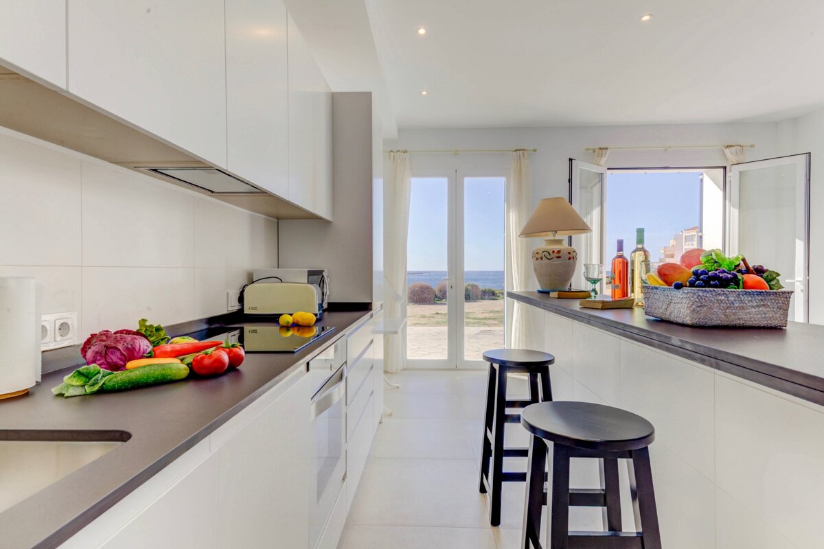 A kitchen with fruits and vegetables on the counter