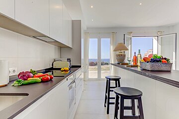 A kitchen with fruits and vegetables on the counter