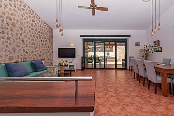 A living room with a sliding glass door and a ceiling fan