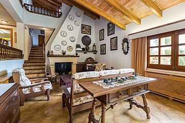A living room with a fireplace and plates on the wall