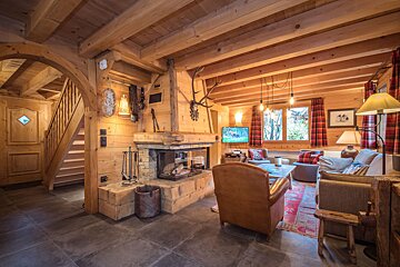 A living room with a fireplace and a television