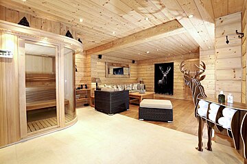 A living room with a deer painting on the wall
