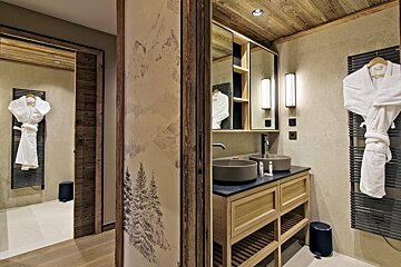 A bathroom with two sinks and a mirror