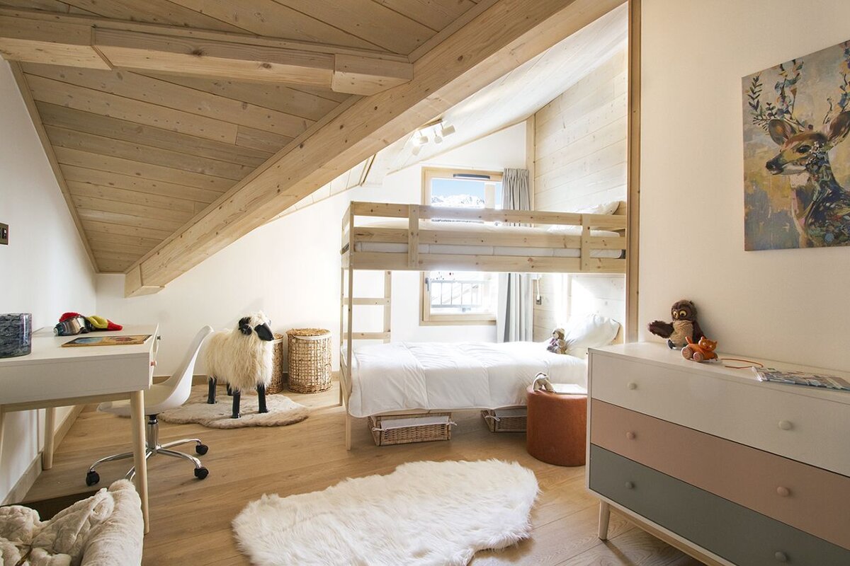A bedroom with a bunk bed and a painting of a deer on the wall