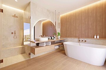 A modern, spacious bathroom with a freestanding tub, glass-enclosed shower, wood slat wall, and arched mirror. Features warm ambient lighting and copper fixtures.