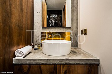A bathroom with a sink and a mirror with the number 80 on the wall