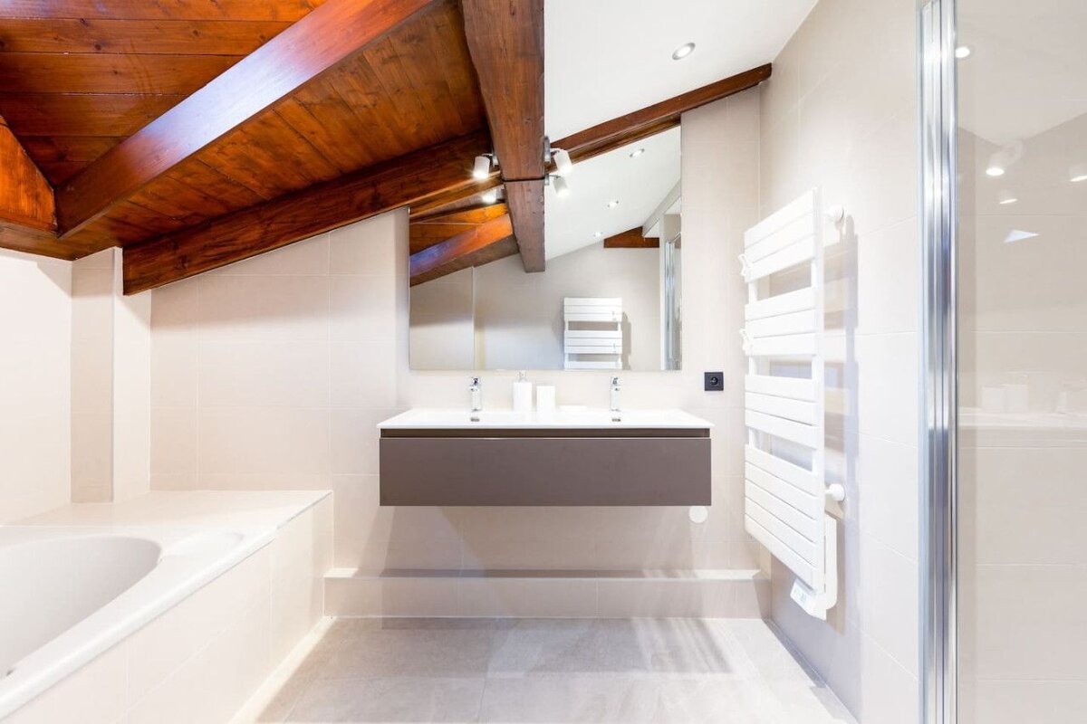 A bathroom with two sinks and a towel rack