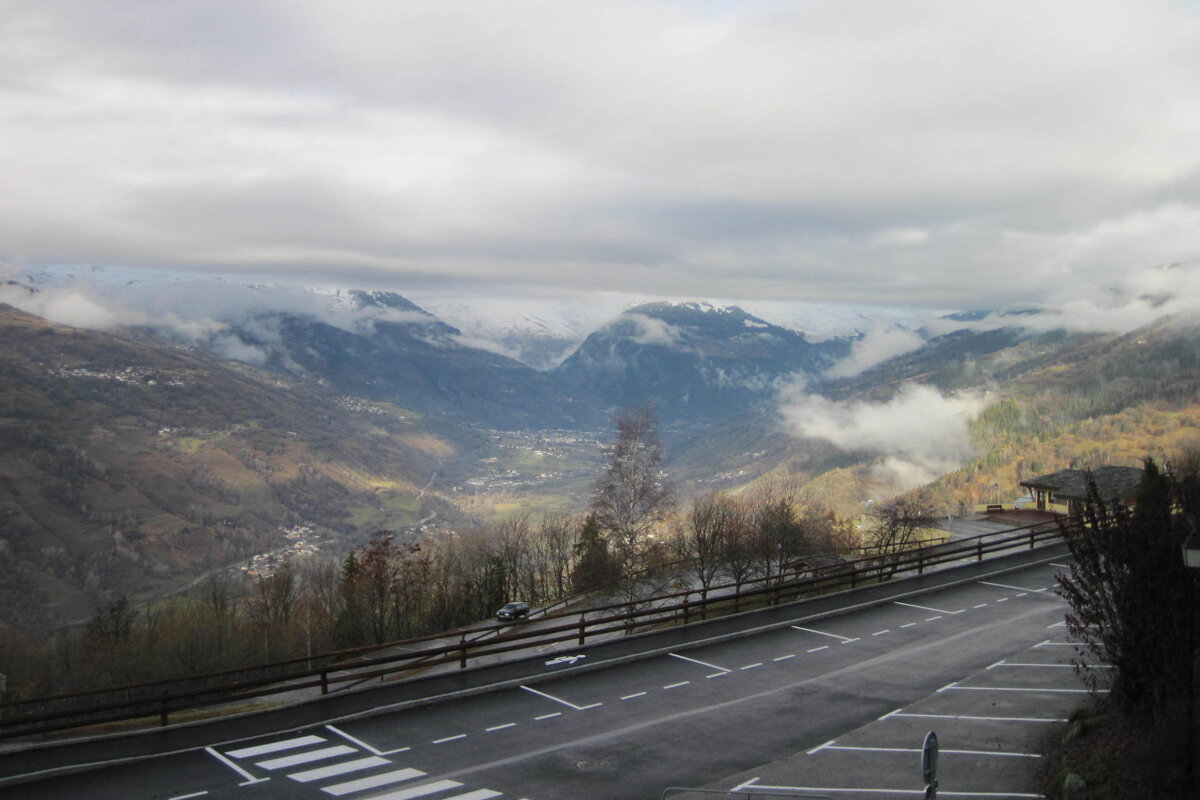 A parking lot with a view of a mountain valley