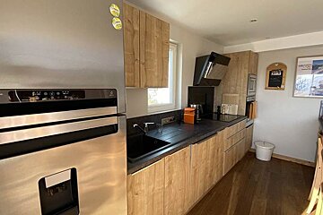 A kitchen with stainless steel appliances and wooden cabinets