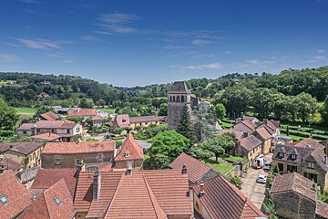 An aerial view of a small village with a church in the middle