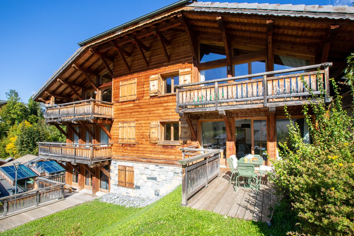 A large wooden house with a large balcony