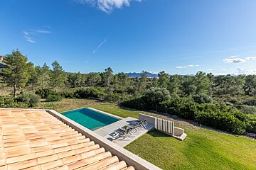A view of a swimming pool from the roof of a house